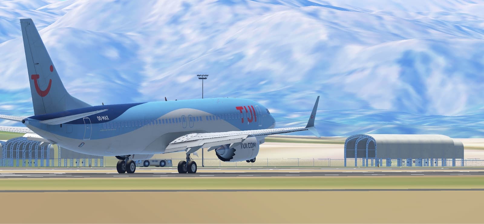 A TUI Boeing 737 MAX taxiing in front of snow-capped mountains