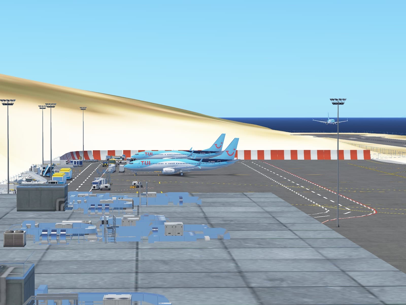 A TUI Boeing 737 rotating on take-off past the airport buildings